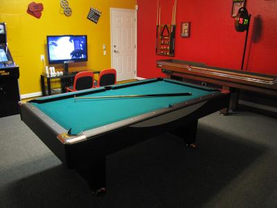 games room with billiards pool table tv arcade and movie memorabilia on walls